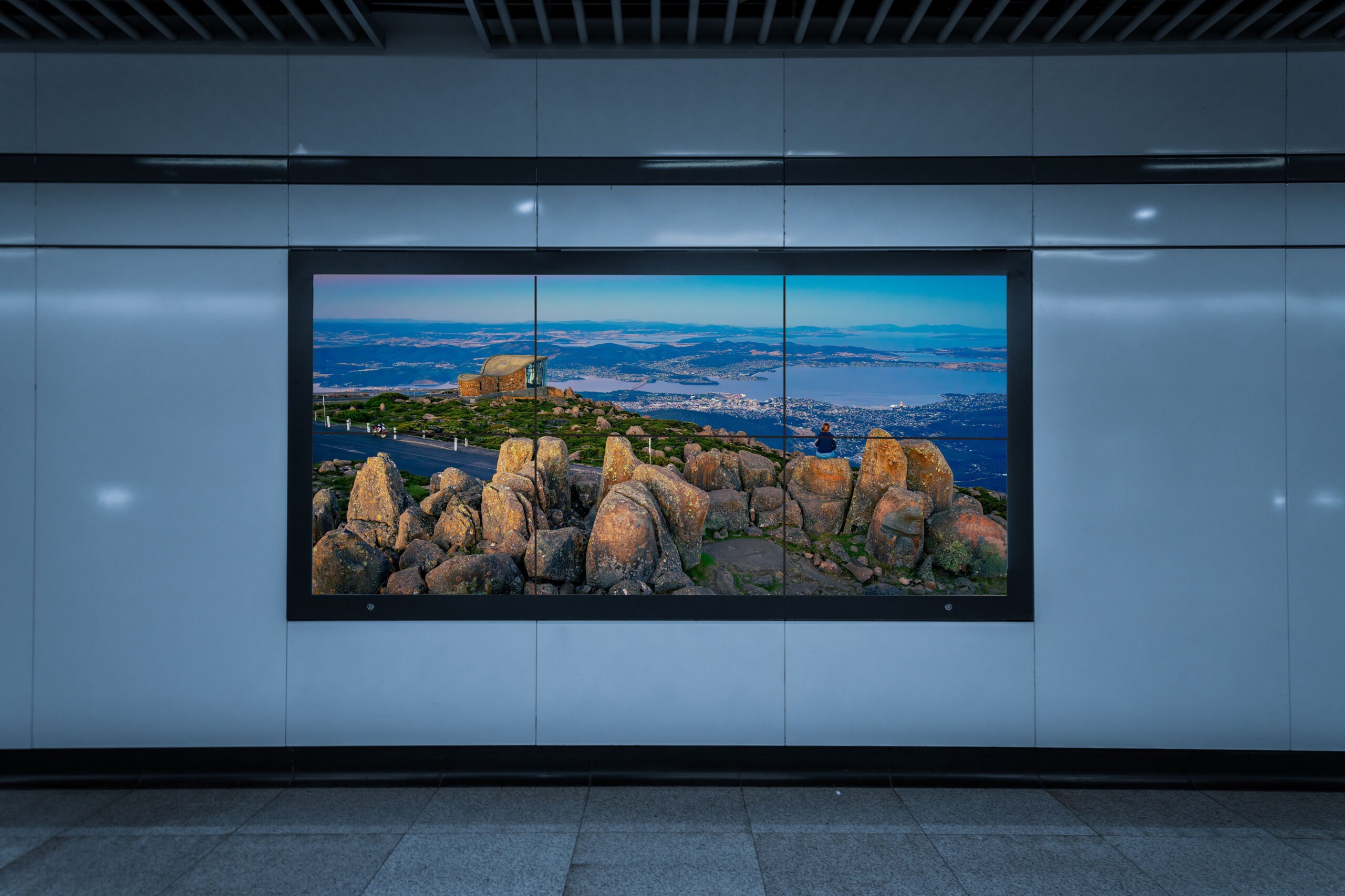 A large television screen illuminated in a dark room, showcasing vibrant colors and images.